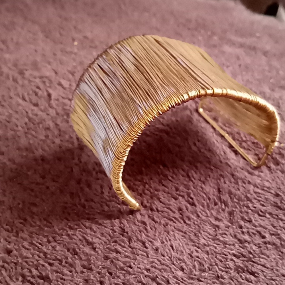Gold colored metal cuff bracelet